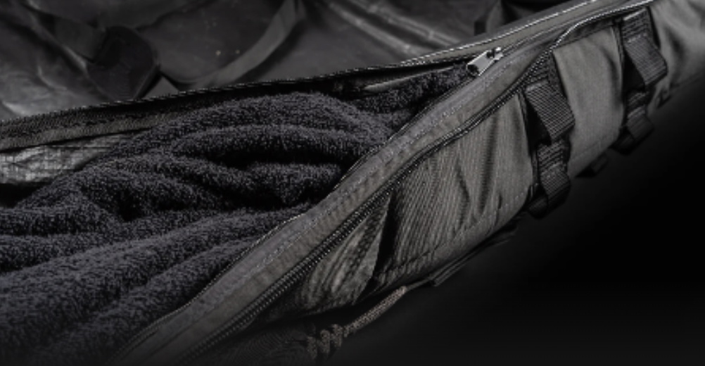 Close-up of a board bag zip running alongside its soft grey fleece inner lining