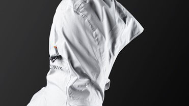 White short-sleeved sailing smock photographed against a dark studio background
