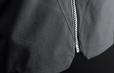 Close-up of the collar and reflective zip on a dark grey waterproof sailing jacket
